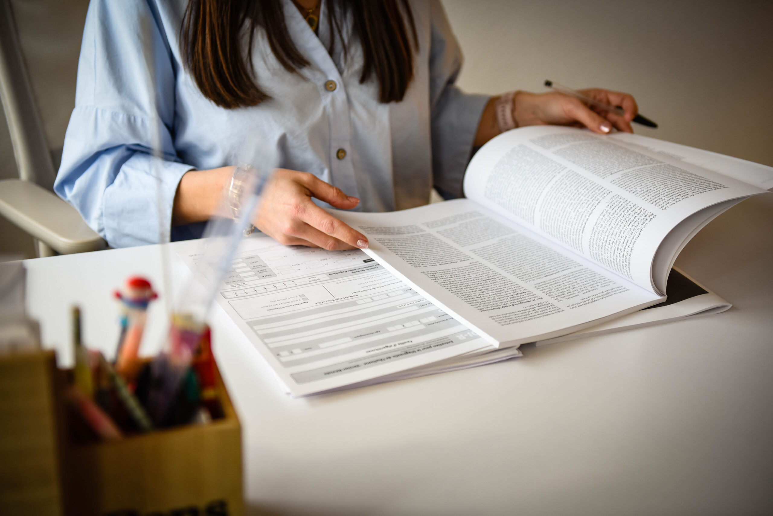 a living room with two chairs and a plant